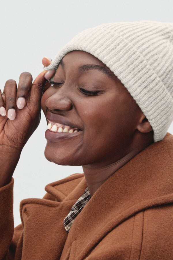 a woman wearing a natural organic cashmere beanie