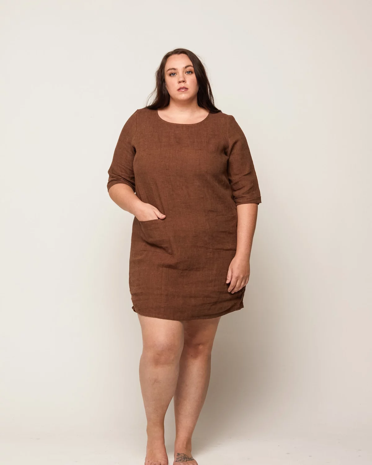 The plus size dress is made from a brown linen.