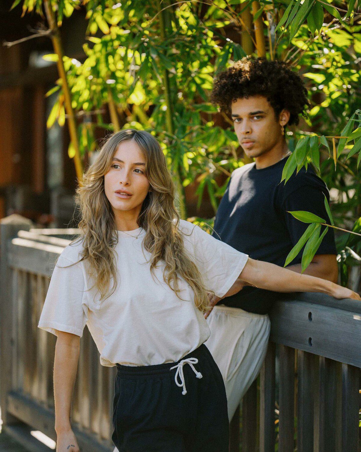 a man and woman wearing regenerative cotton gender neutral tees from harvest & mill