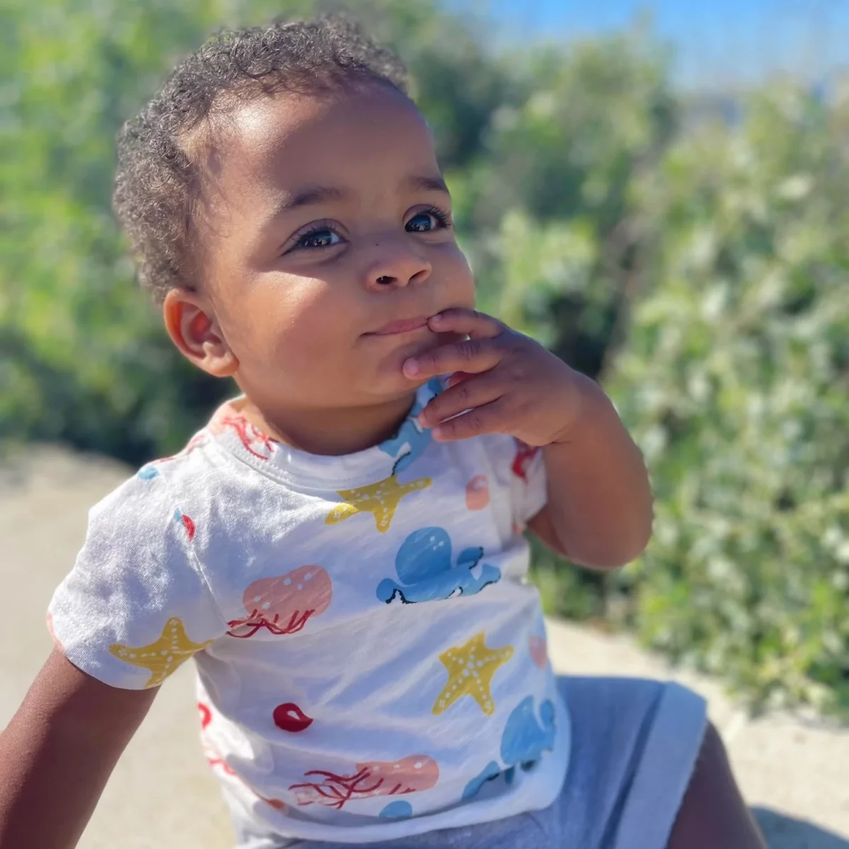 A toddler wearing an organic tshirt from Monica & Andy.