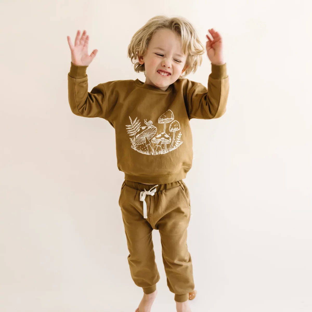 A kid dressed in organic clothes from Make Make Organics