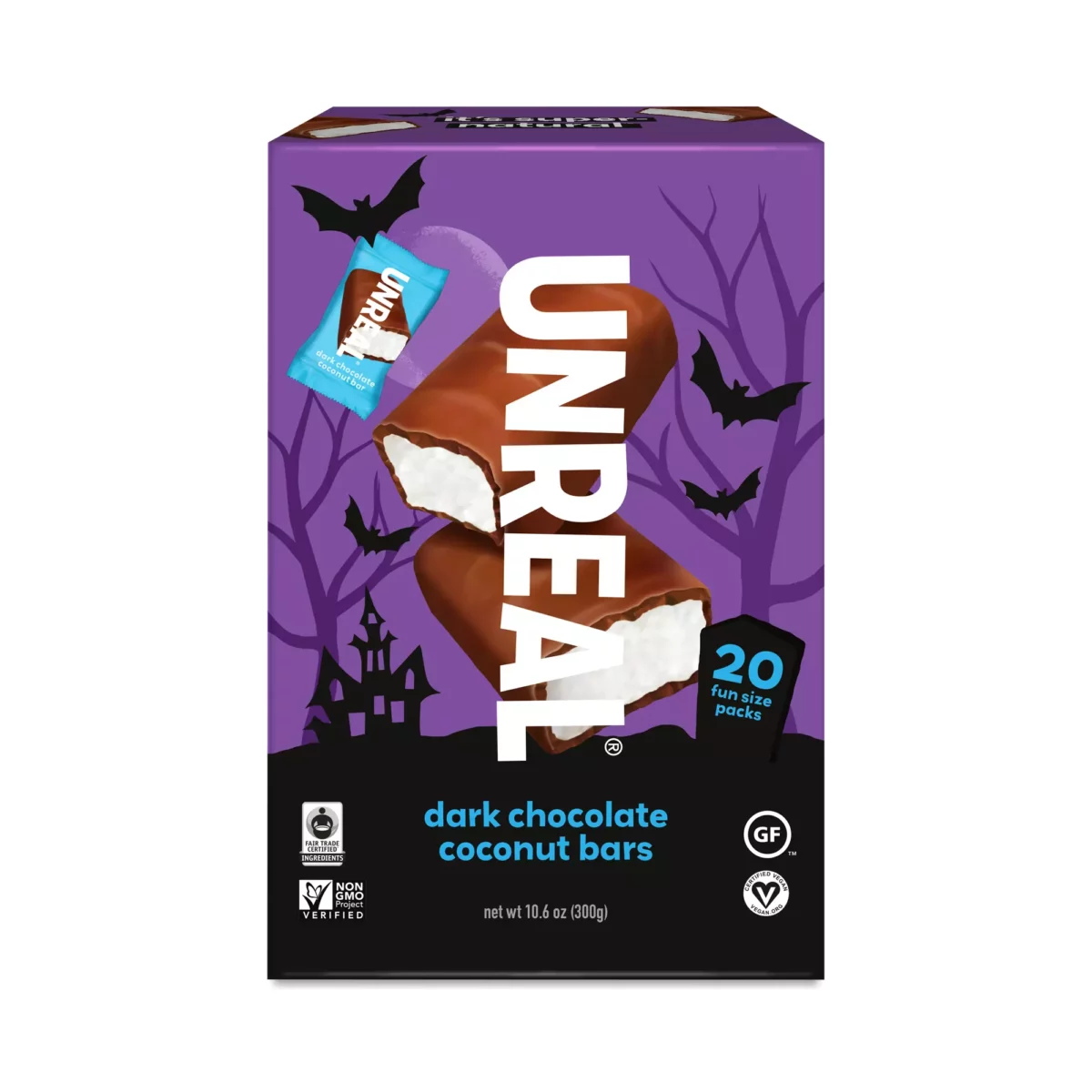 
A rectangular purple box of Unreal brand dark chocolate coconut bars is shown from a slight angle, with illustrations of bats, a haunted house, and trees on the front.