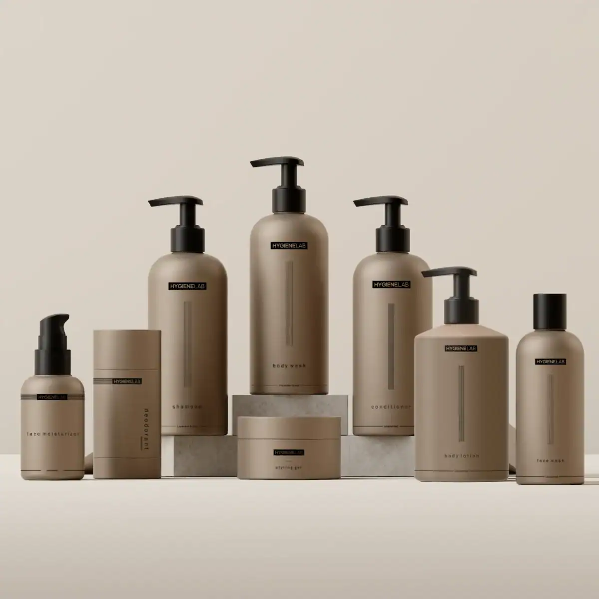 The photo features a symmetrical arrangement of eight neutral-toned HYGIENE:LAB cosmetic or personal care bottles and jars, some with black pump dispensers, set against a light background with two products raised on small square pedestals.