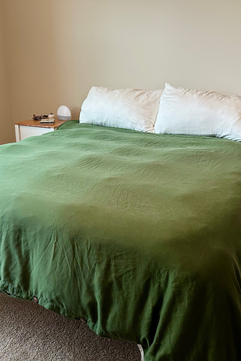 Green Sijo duvet cover on bed in minimalist bedroom