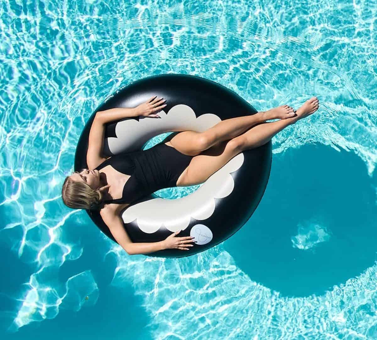 A woman wearing a swimwear is on a non-toxic pool ring.