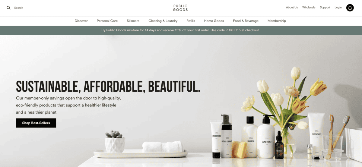 The photo displays the homepage for Public Goods, featuring various personal care products like shampoo and toothpaste alongside a vase of tulips and the text "SUSTAINABLE, AFFORDABLE, BEAUTIFUL".
