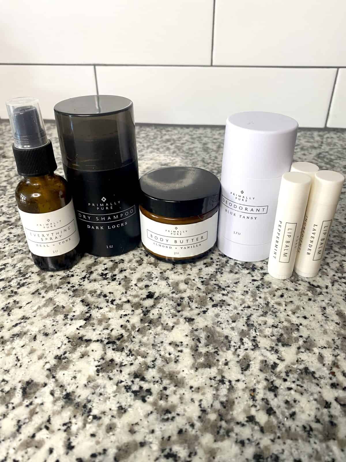 several of primally pure's skincare products lined up on a countertop