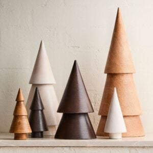 Set of minimalist wooden Christmas tree decor pieces in varying sizes and natural tones.