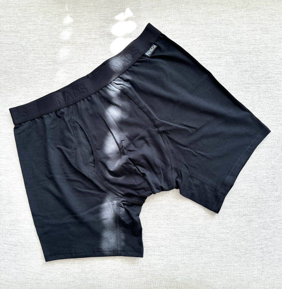 a pair of black Nads boxer briefs laying flat against a cream-colored surface