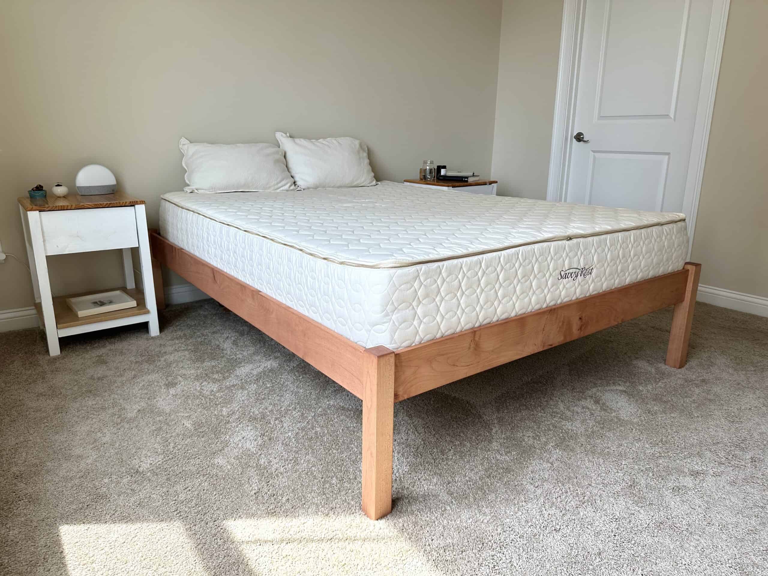 An image of a bed and mattress from Savvy Rest inside the bedroom, with side tables.