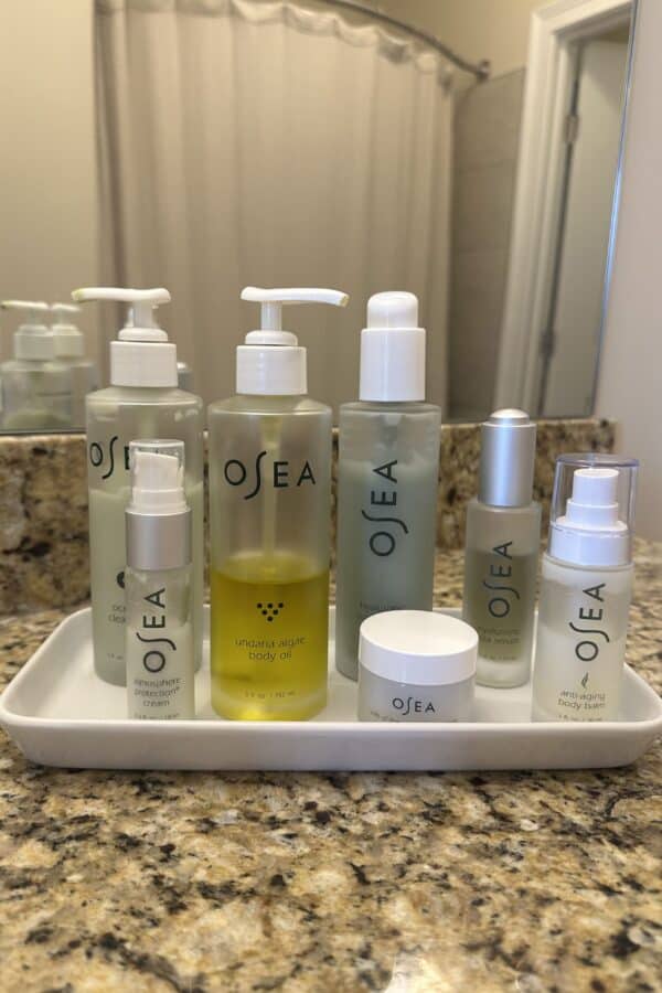 A collection of OSEA travel set products inside the white tray