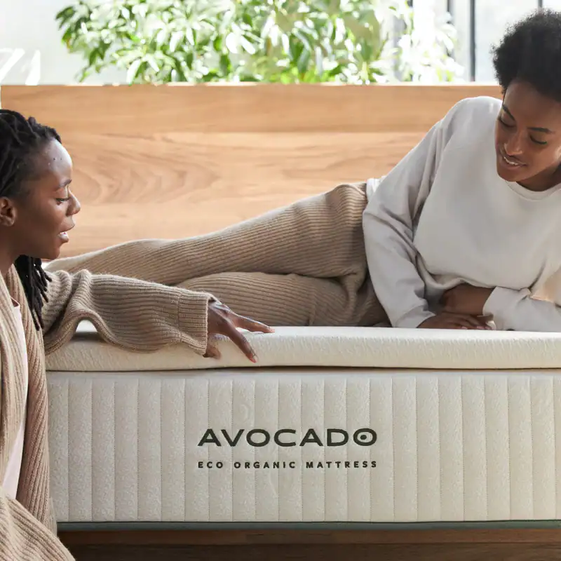 two women looking at the organic mattress topper from Avocado