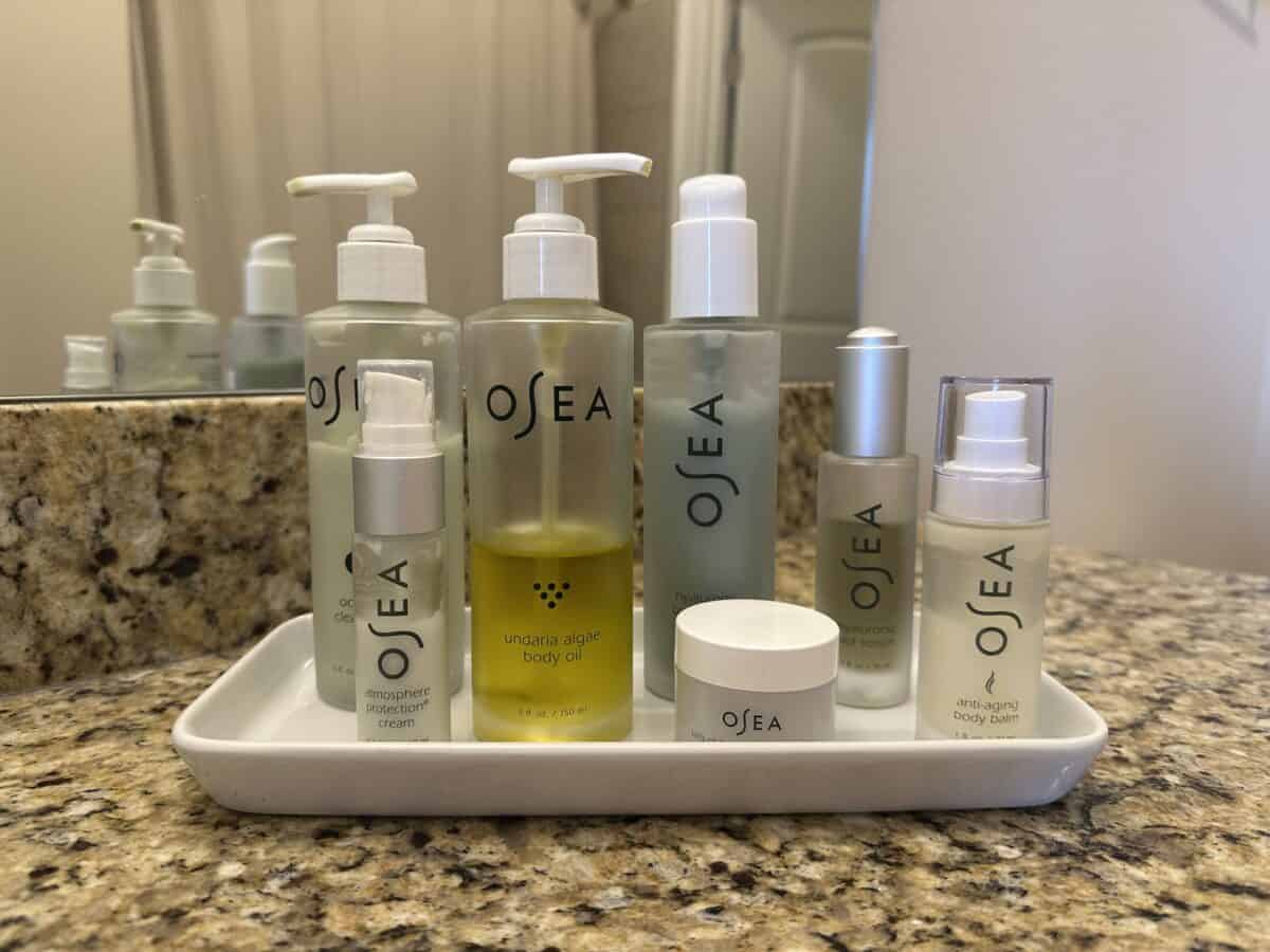 A set of OSEA products neatly placed on a tray in the bathroom.