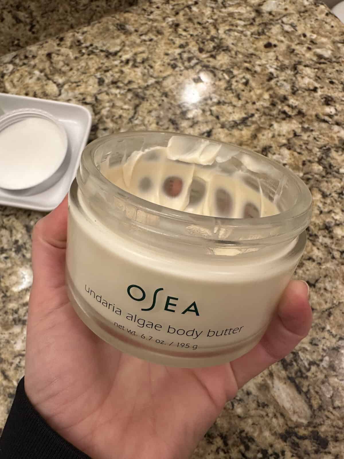 A person holding the OSEA Undaria Algae Body Butter 