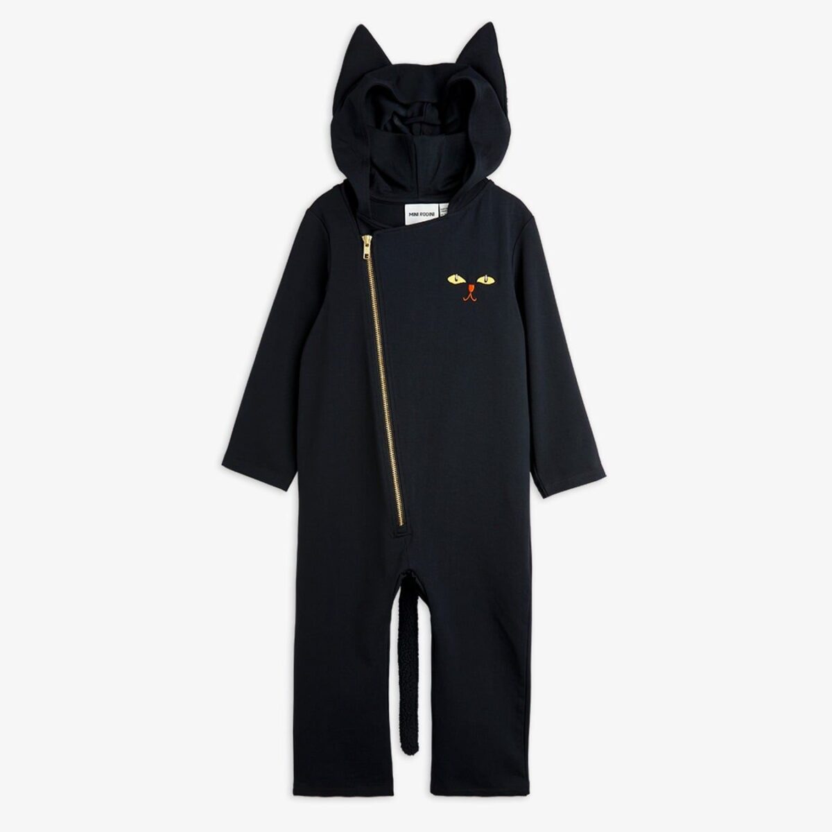 A black one-piece childrens jumpsuit with a hood featuring cat ears, a slanted gold zipper, and an embroidered cat face on the chest. The jumpsuit also has a small, attached tail at the back.