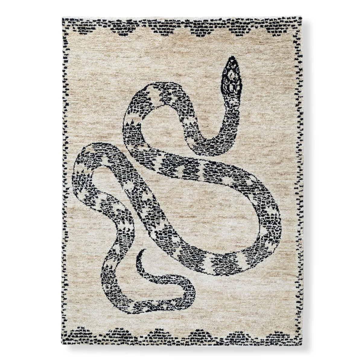 The photo displays a beige rug featuring a coiled, dark, snake-like design with a decorative border, set against a plain white background.