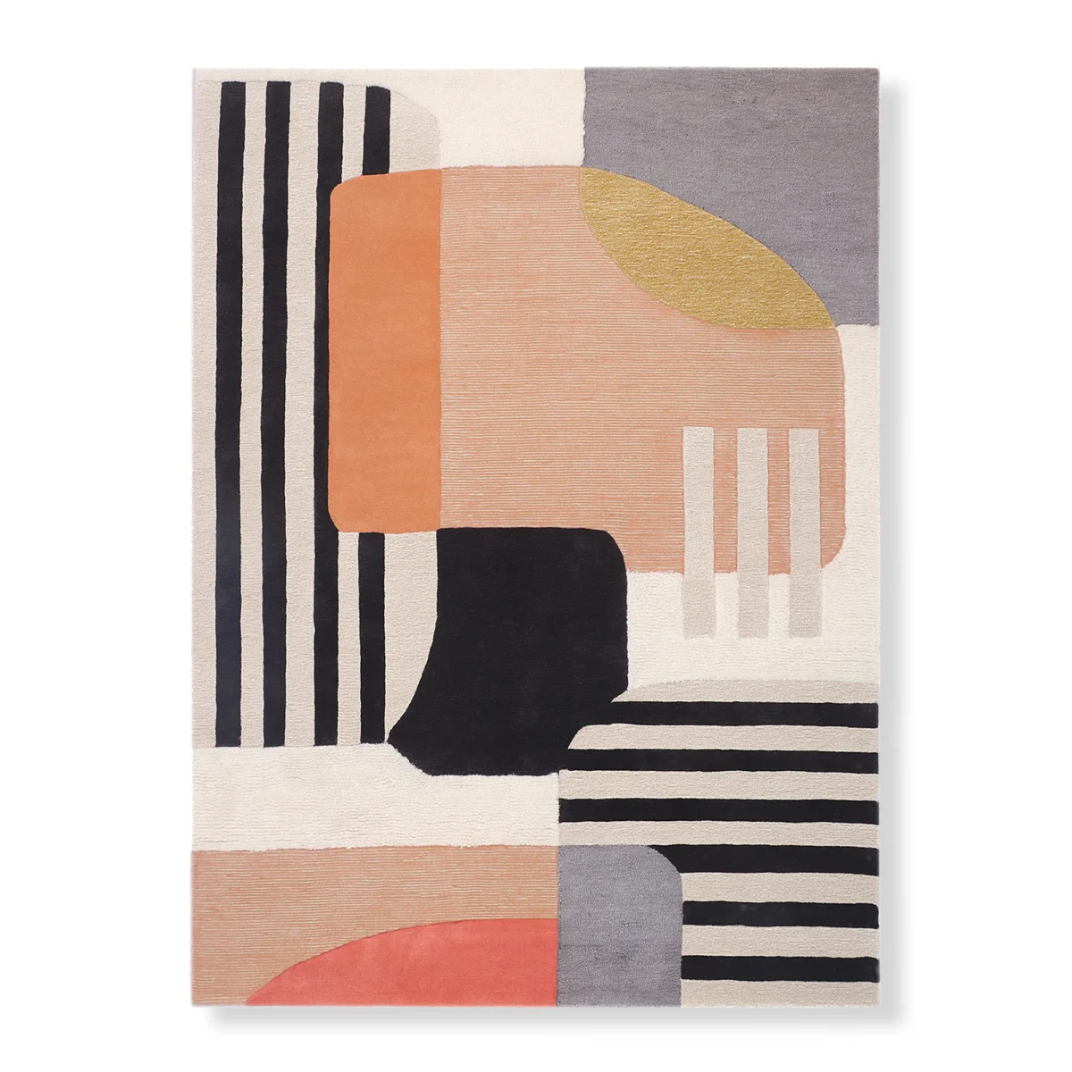 The photo displays a modern area rug with a large abstract design featuring blocks and stripes in colors like black, white, gray, orange, and a touch of gold.