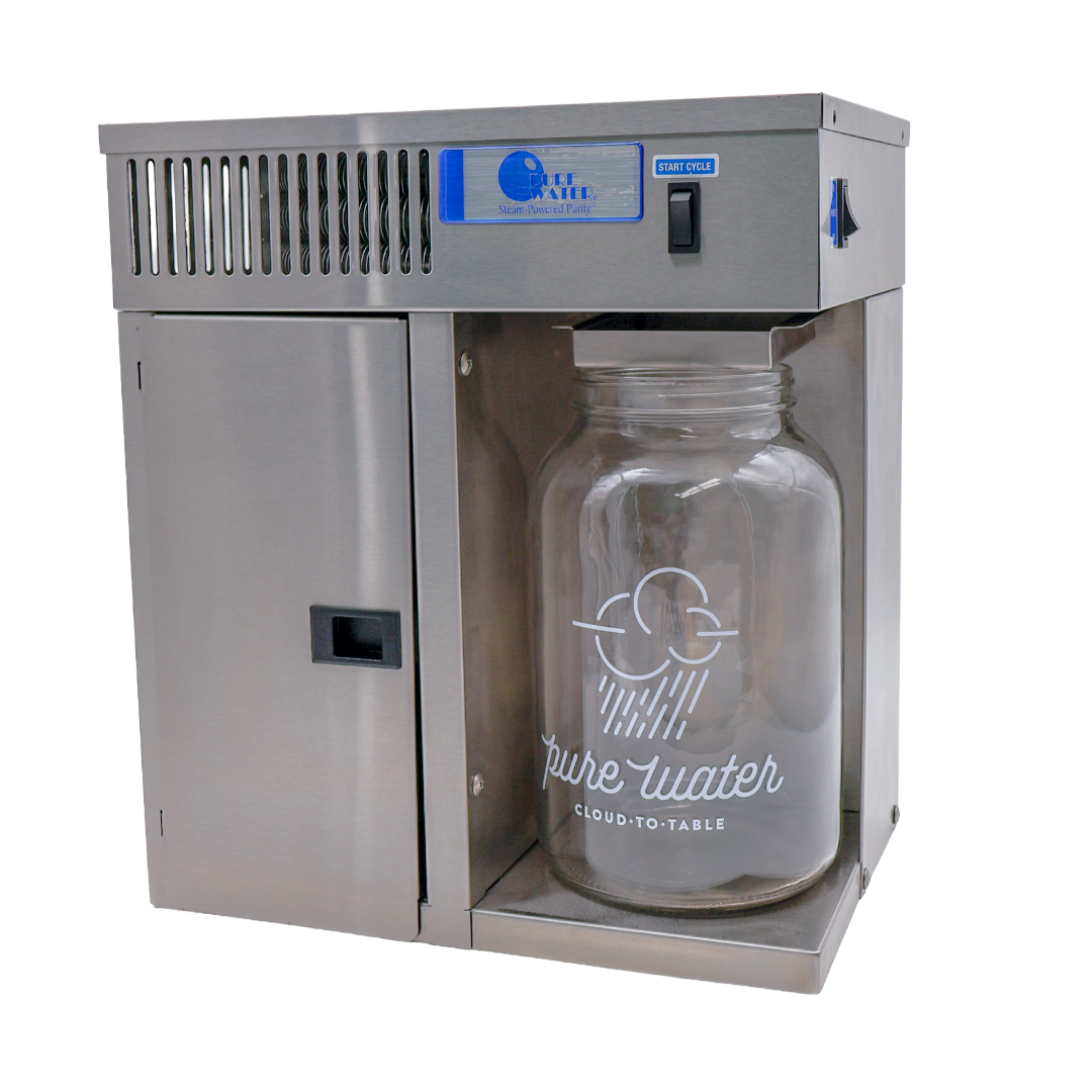 The image features a stainless steel "Pure Water" countertop distiller with a large glass collection jar labeled "pure water cloud-to-table".