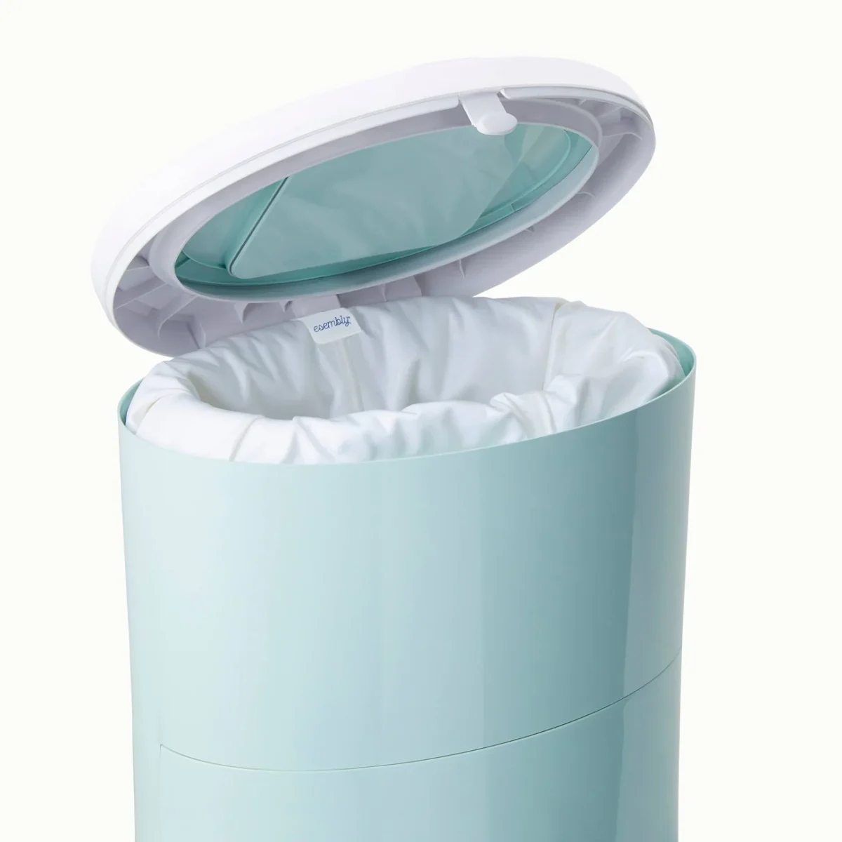 A light blue cylindrical trash can with a white liner inside. The lid is open, showing the inner rim and part of the interior. The background is plain and neutral in color.