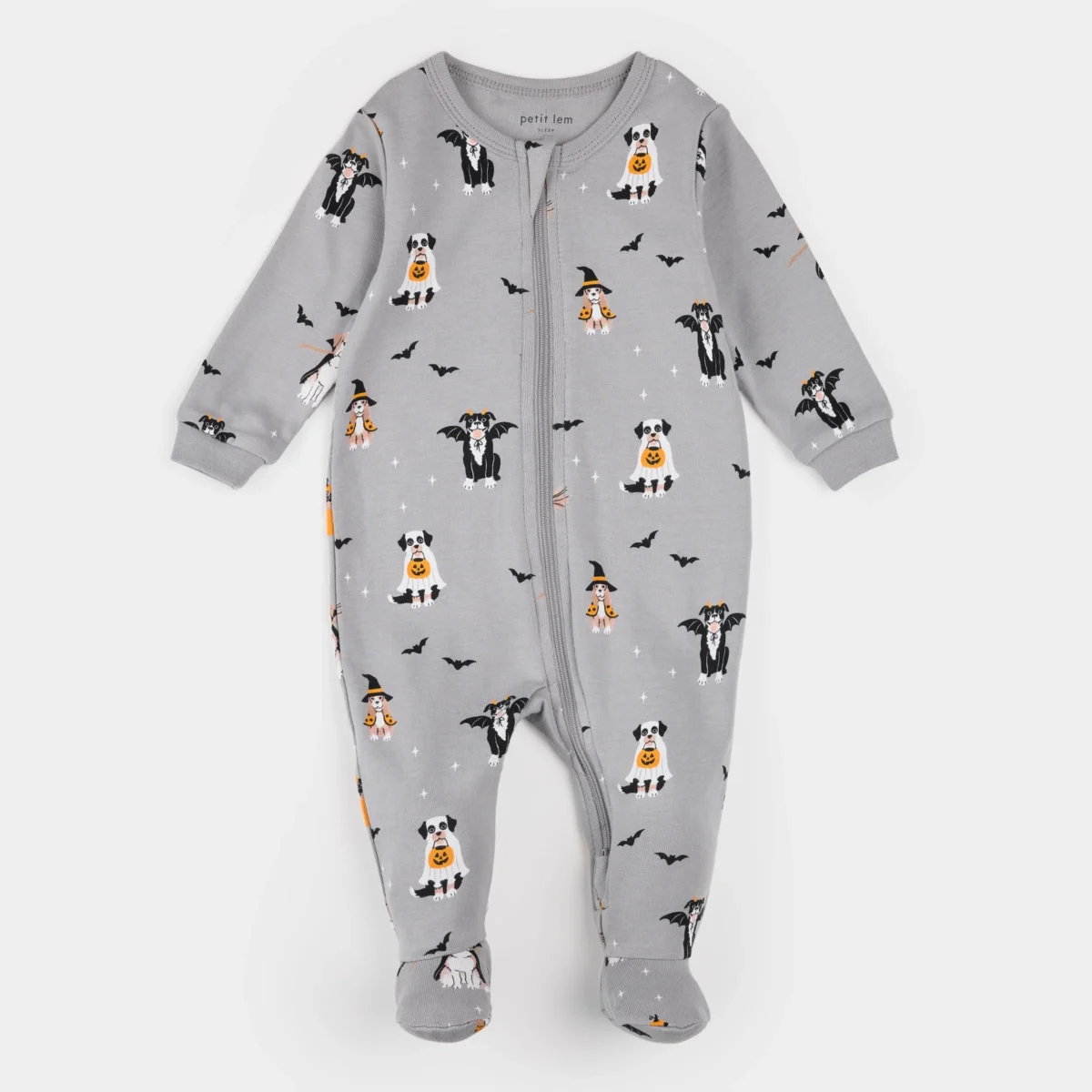 Gray footed baby onesie with a front zipper, featuring a Halloween pattern of dogs in costumes, bats, and stars. The background is solid light gray and the print colors include black, white, and orange.